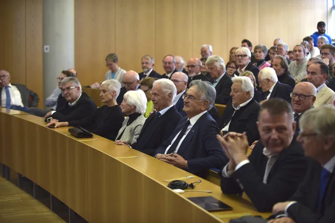 Color photo of a lecture hall full of attendees