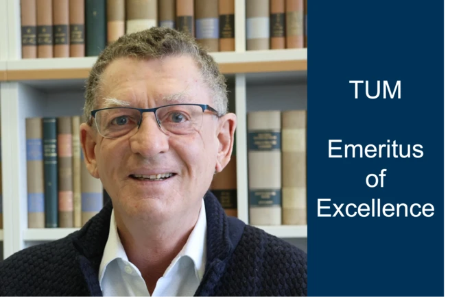 Color photo of a person wearing glasses smiling into the camera