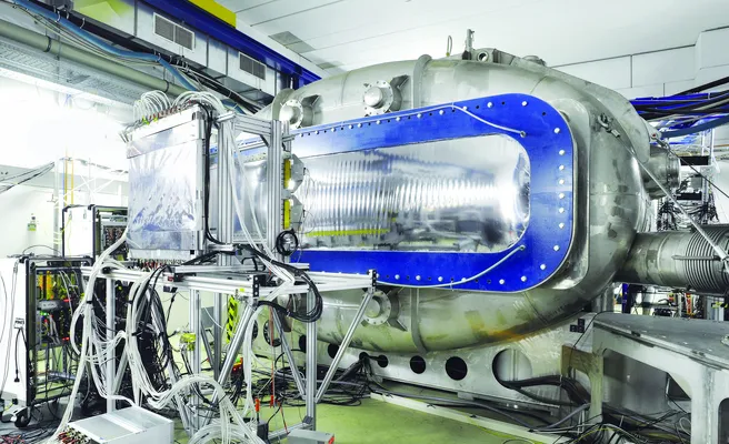 Color photo of a large experimental device in silver and blue